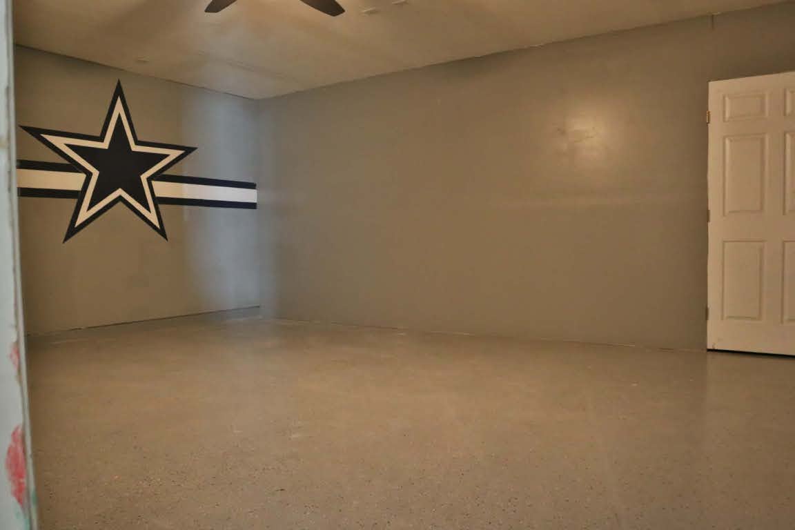 717 Blair Avenue Bastrop, TX 78602 - Photo 21 of 27 Spare room with speckle patterned floor and ceiling fan