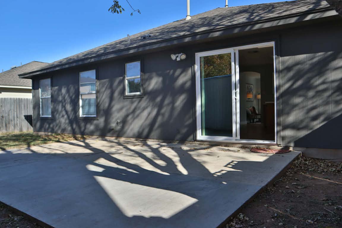 717 Blair Avenue Bastrop, TX 78602 - Photo 26 of 27 Back of house featuring roof with shingles and a patio