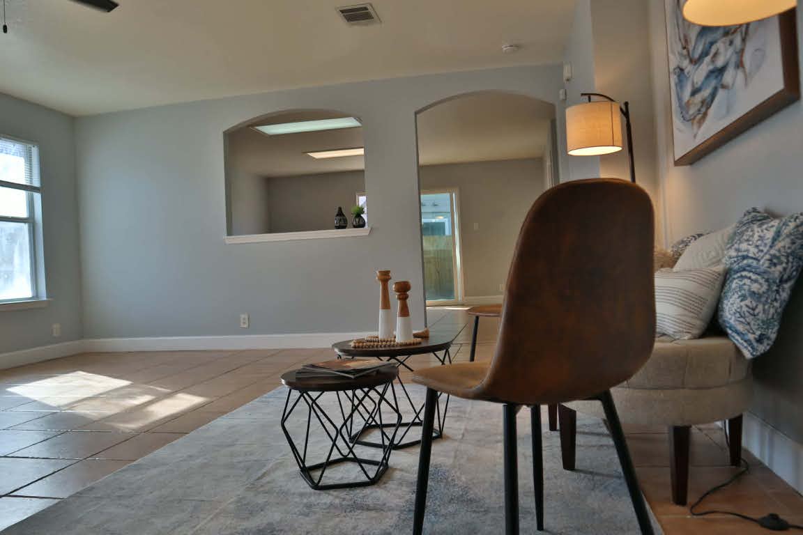 717 Blair Avenue Bastrop, TX 78602 - Photo 5 of 27 Living area featuring arched walkways and tile patterned flooring