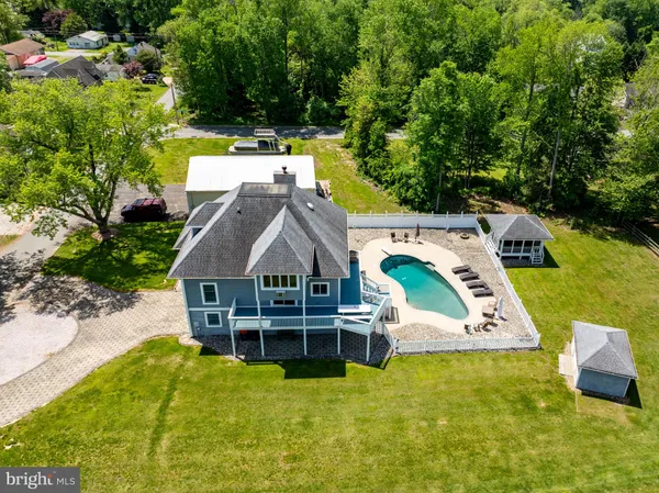 an aerial view of a house with swimming pool garden and patio