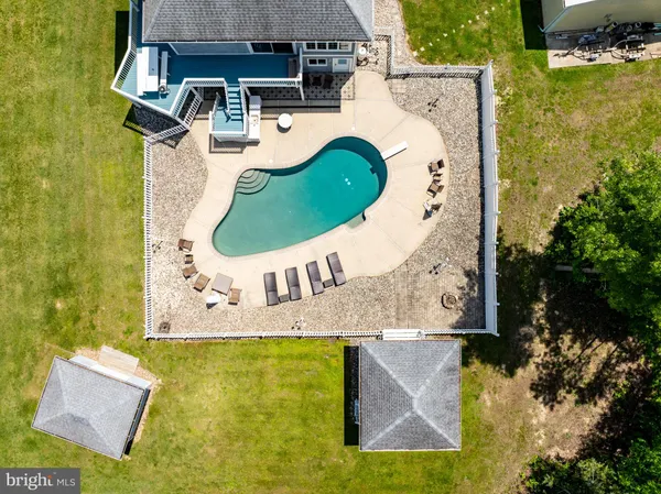 an aerial view of a house with swimming pool garden and lake view
