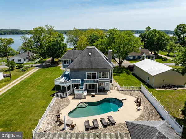 a view of an ocean with boats and trees in the background