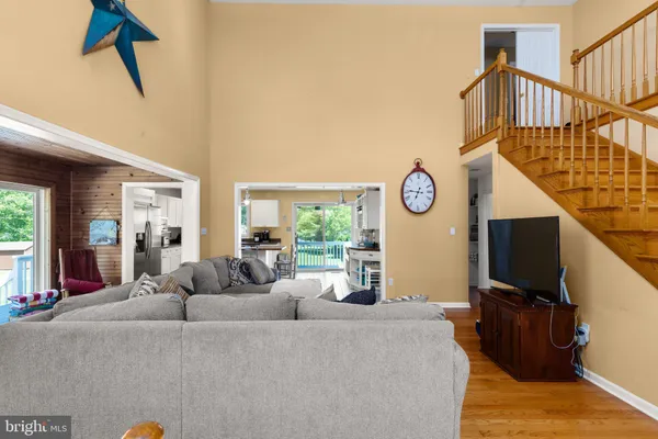 a living room with furniture a window and a flat screen tv