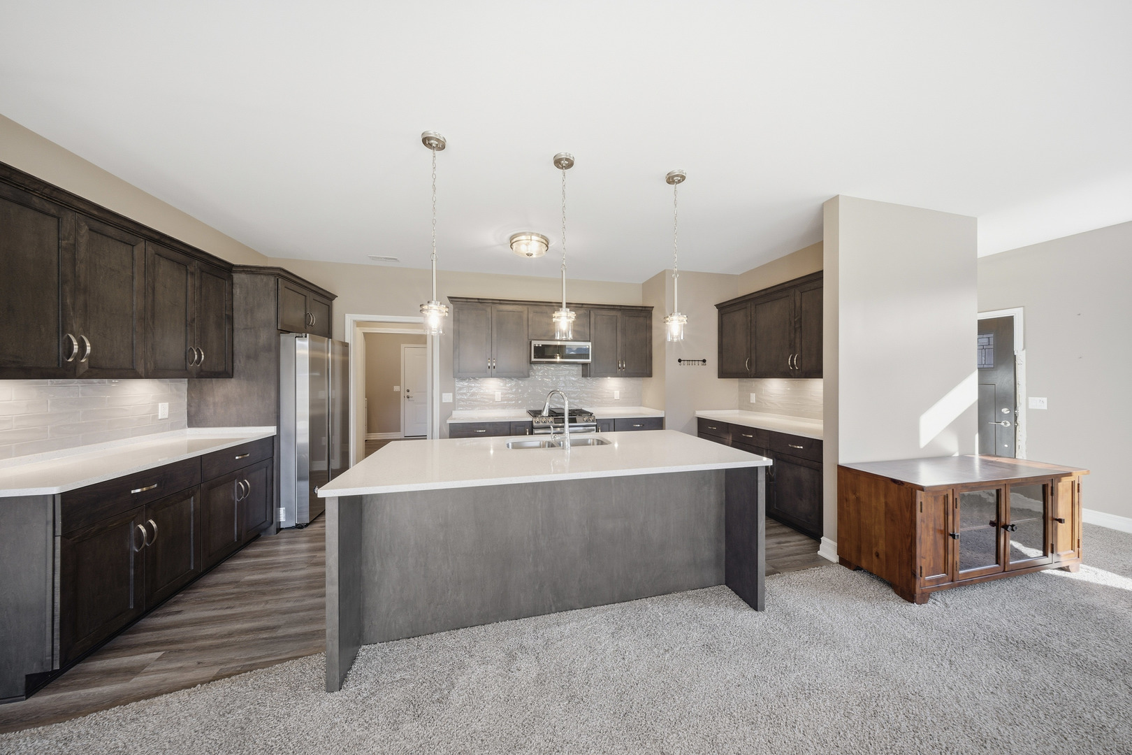 437 Stearn Drive, Unit 437 Genoa, IL 60135 - Photo 13 of 50 a large kitchen with kitchen island a sink stainless steel appliances and cabinets