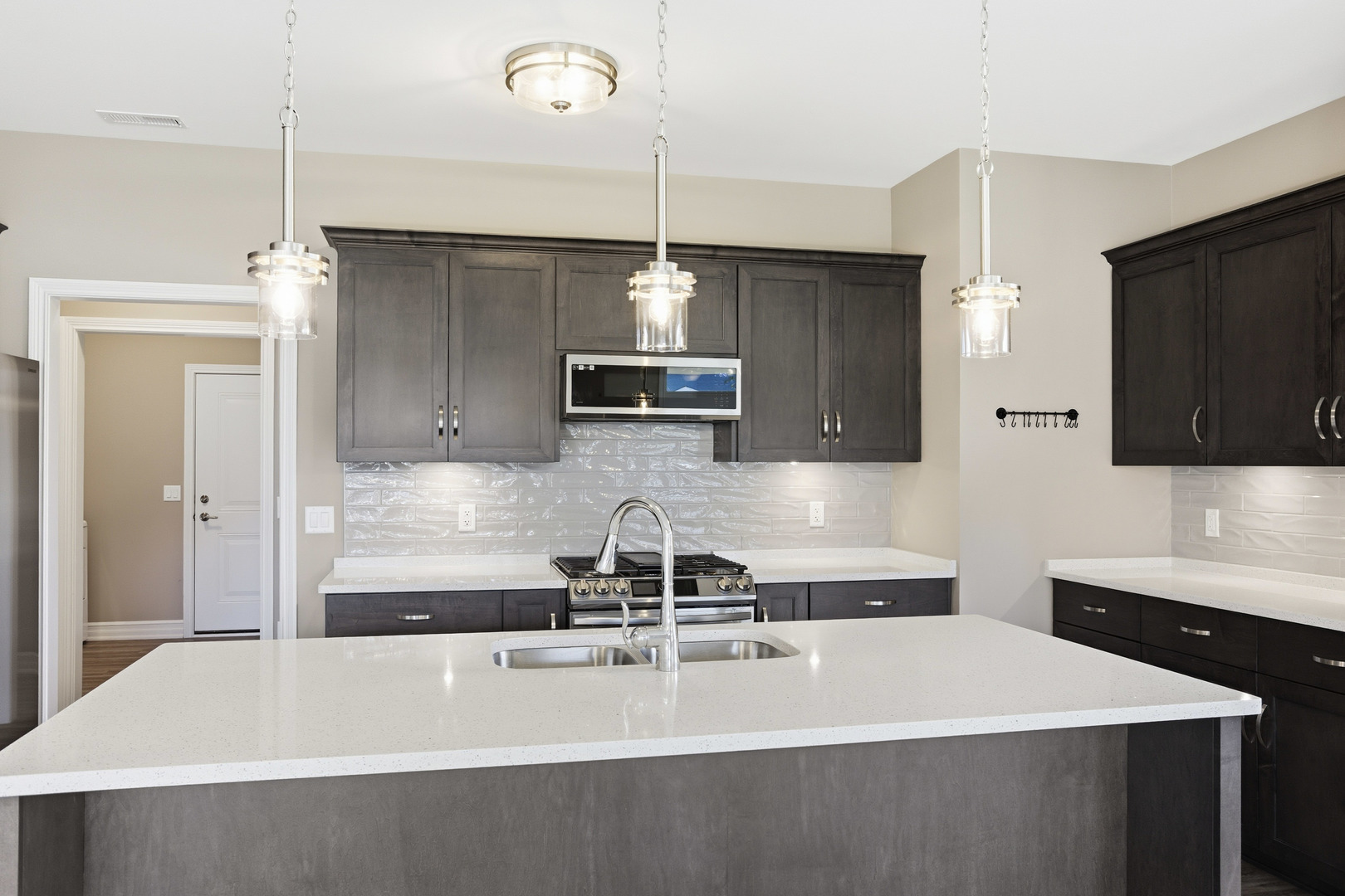 437 Stearn Drive, Unit 437 Genoa, IL 60135 - Photo 14 of 50 a kitchen with a sink a counter top space stainless steel appliances and cabinets