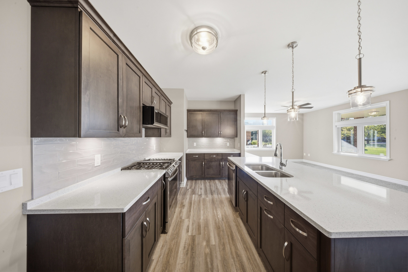 437 Stearn Drive, Unit 437 Genoa, IL 60135 - Photo 15 of 50 a kitchen with a sink stove and wooden cabinets
