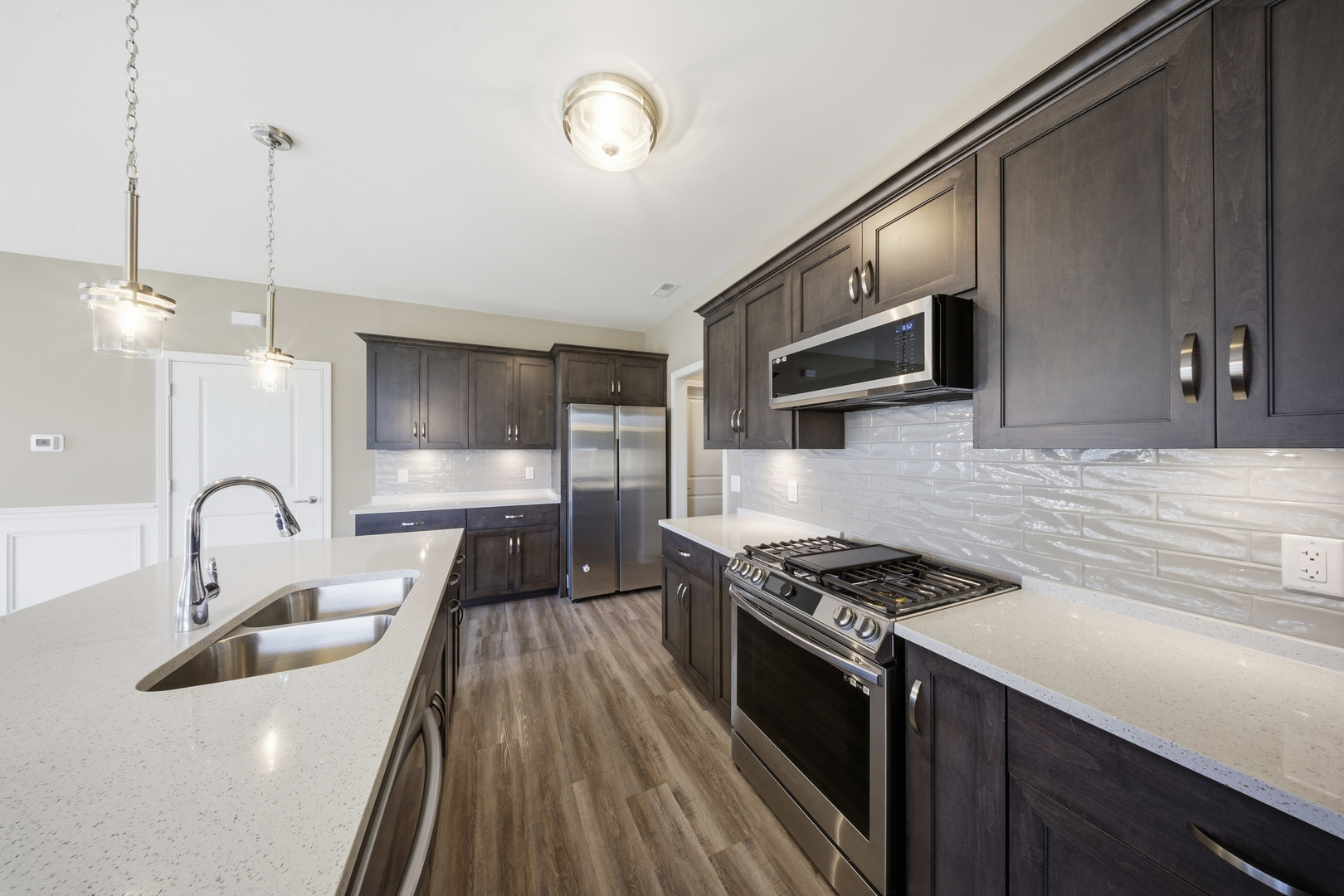 437 Stearn Drive, Unit 437 Genoa, IL 60135 - Photo 17 of 50 a kitchen with counter top space a sink stainless steel appliances and cabinets