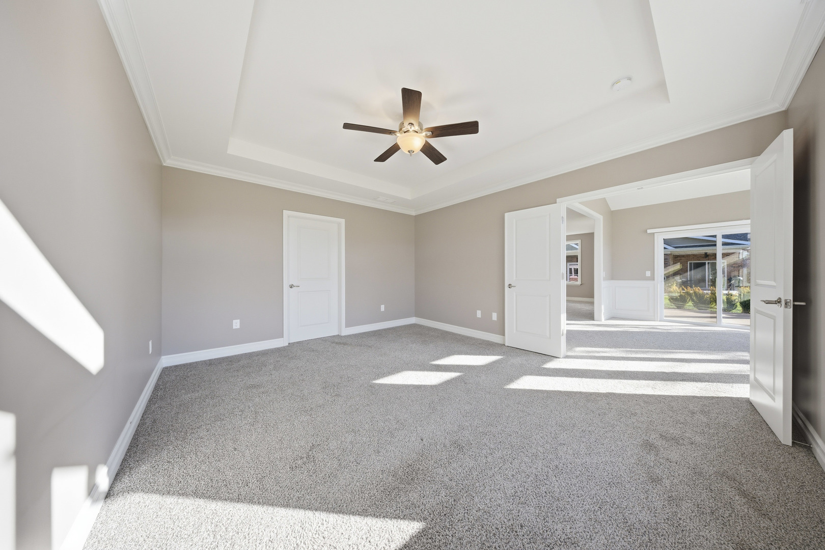 437 Stearn Drive, Unit 437 Genoa, IL 60135 - Photo 28 of 50 a view of a livingroom with a ceiling fan & windows