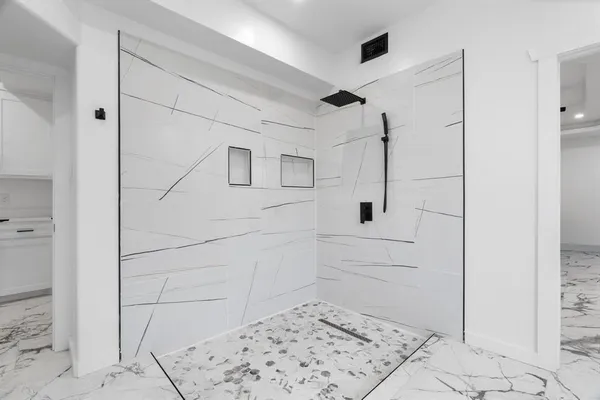 a bathroom with a sink a toilet and shower