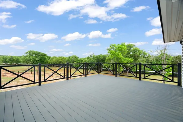 a view of a house with a wooden bench wooden floor