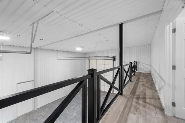 an empty room with wooden floor ceiling fan and window