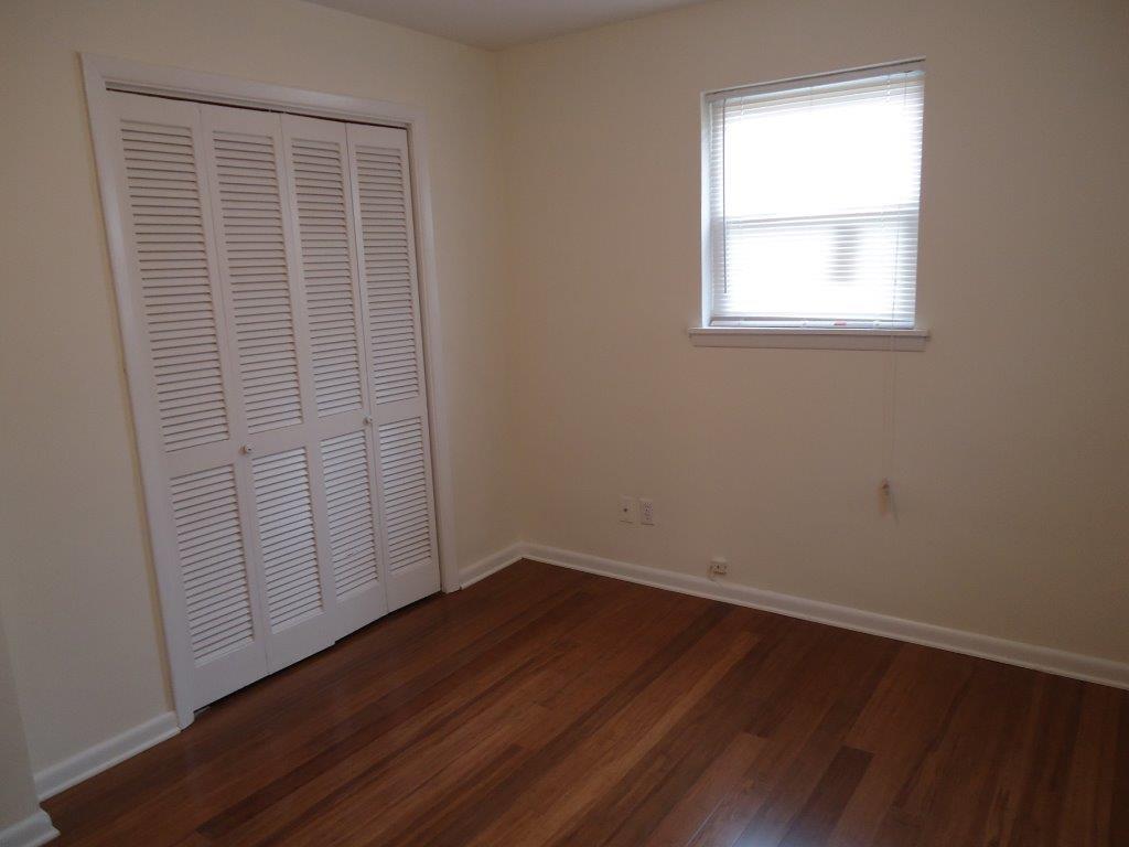 800 St James Church Road Newton, NC 28658 - Photo 12 of 27 an empty room with wooden floor and windows