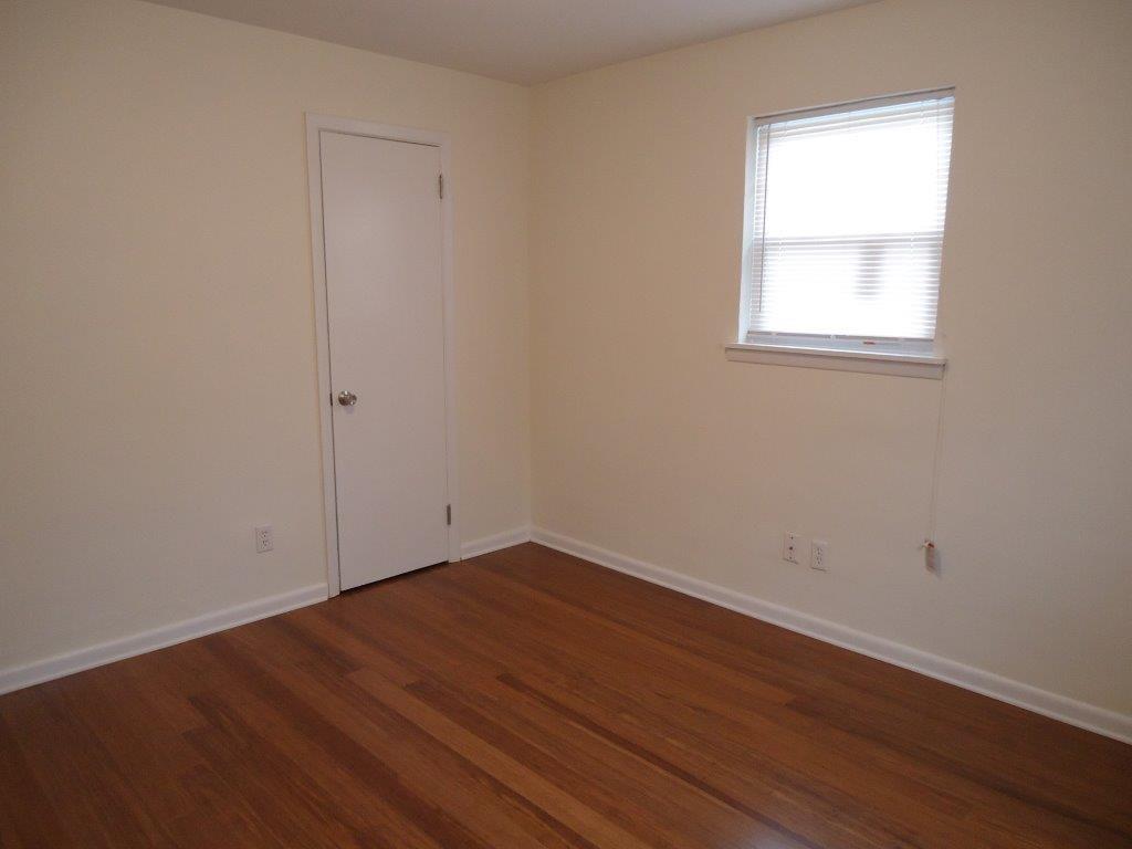 800 St James Church Road Newton, NC 28658 - Photo 13 of 27 an empty room with wooden floor and windows