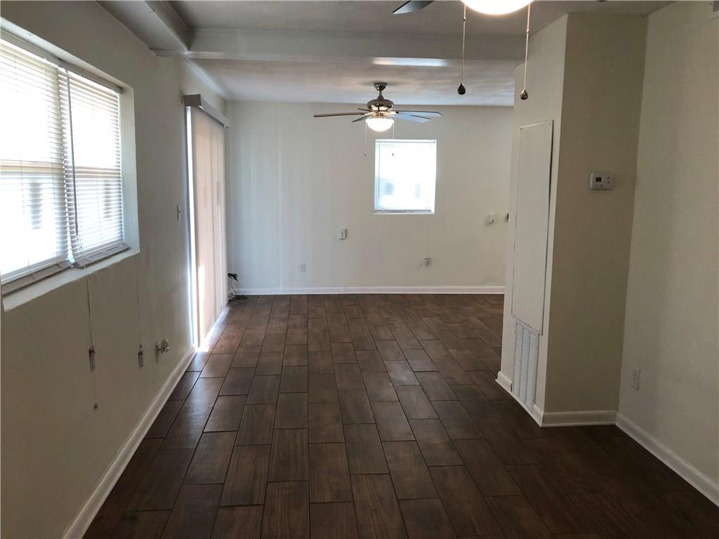 800 St James Church Road Newton, NC 28658 - Photo 19 of 27 en empty room with wooden floor and windows