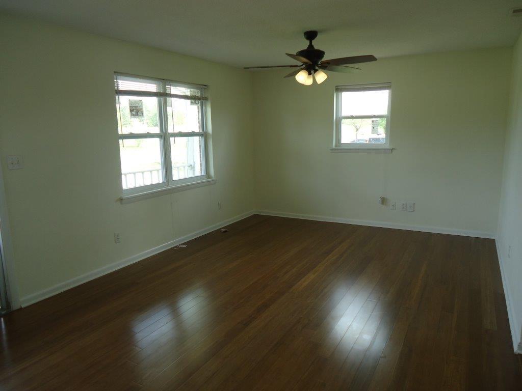 800 St James Church Road Newton, NC 28658 - Photo 3 of 27 an empty room with wooden floor and windows