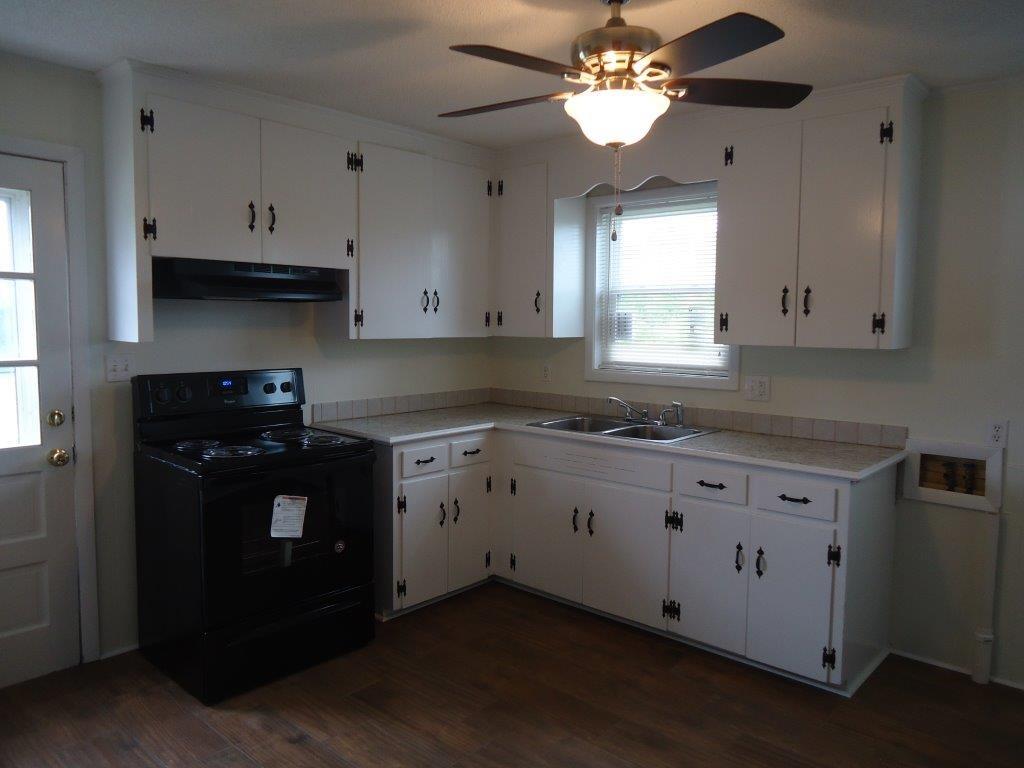 800 St James Church Road Newton, NC 28658 - Photo 8 of 27 a kitchen with granite countertop white cabinets white stainless steel appliances and a window