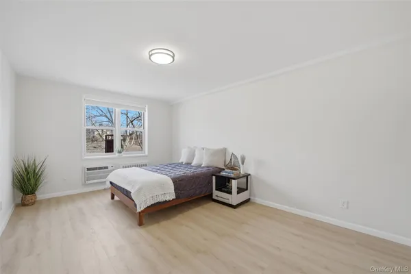 a spacious bedroom with a bed and a table