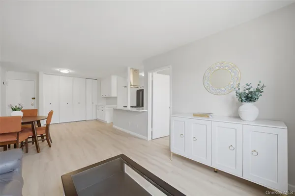 a large white kitchen with wooden floor