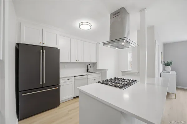 a kitchen with a refrigerator and a stove top oven
