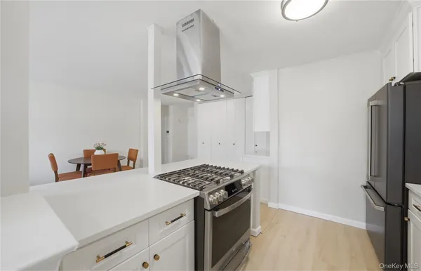 a kitchen with stainless steel appliances a refrigerator and a stove top oven