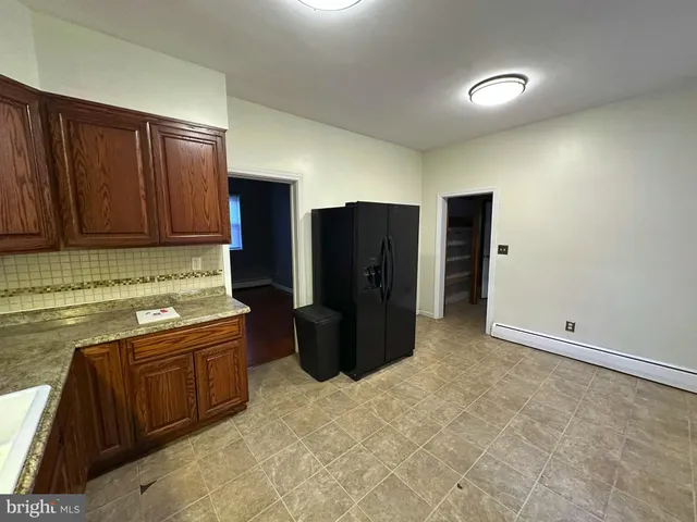 a kitchen with a refrigerator and a sink