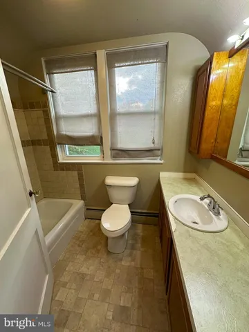a bathroom with a sink a toilet and a bathtub