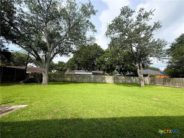 a view of a house with swimming pool and a yard
