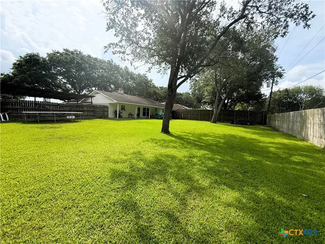 a swimming pool with outdoor seating and yard