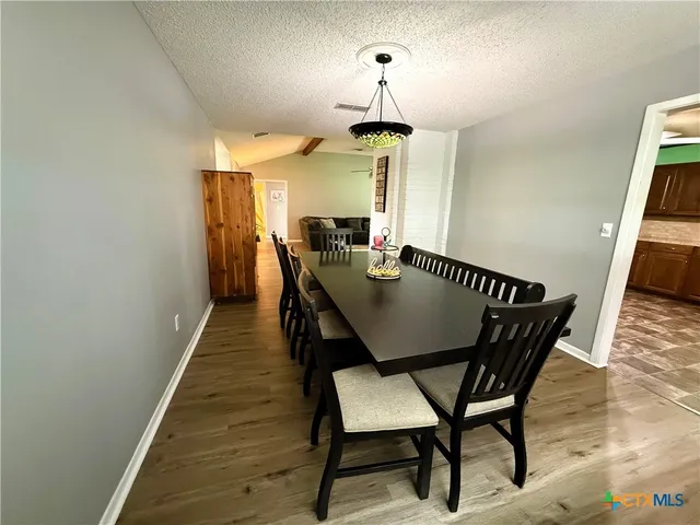 a view of a dining room with furniture and window