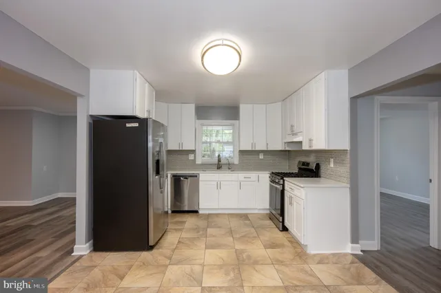 a kitchen with a refrigerator and a sink