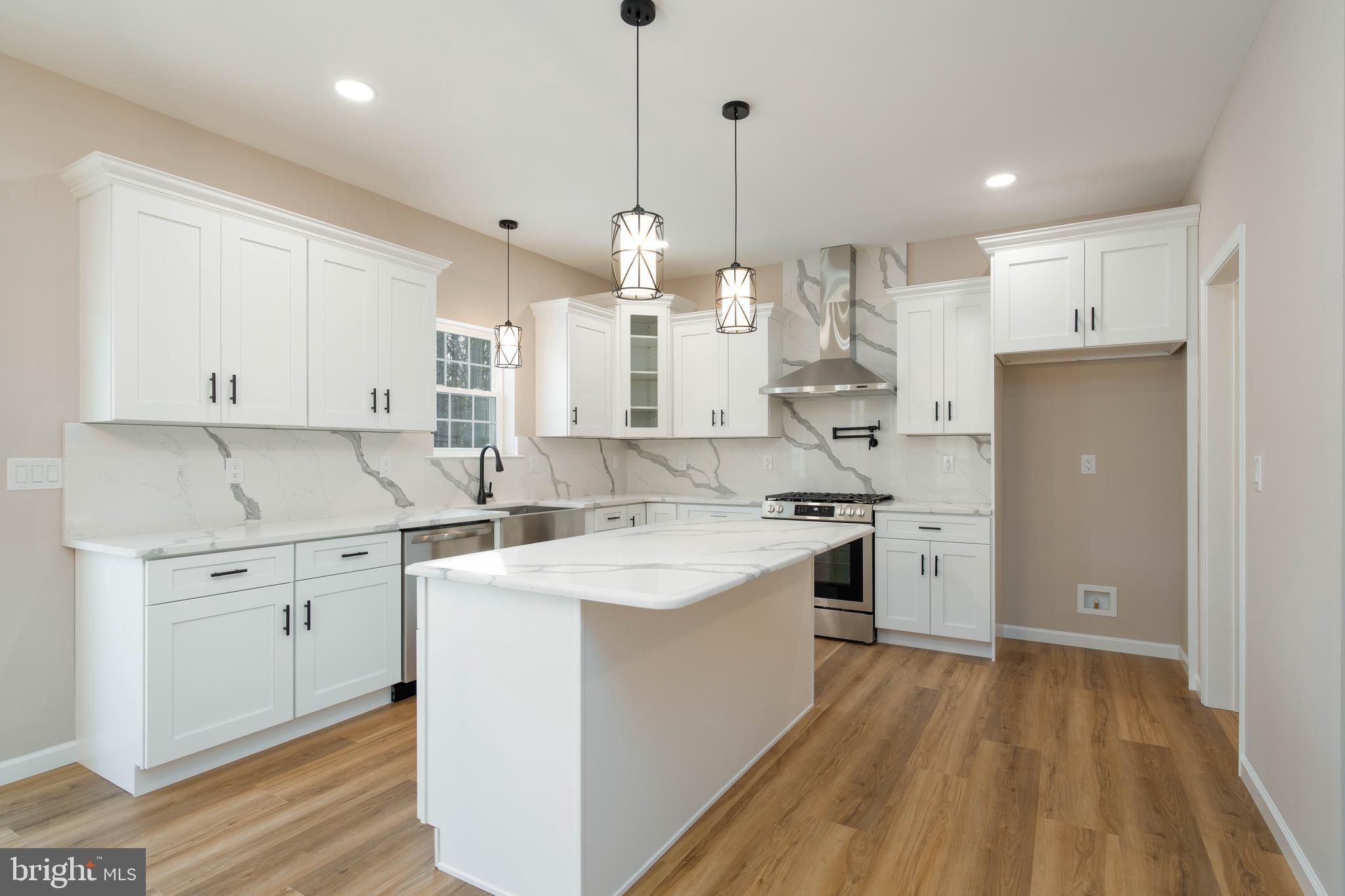 1162 South Spring Road Vineland, NJ 08361 - Photo 12 of 57 a kitchen with white cabinets sink and stainless steel appliances
