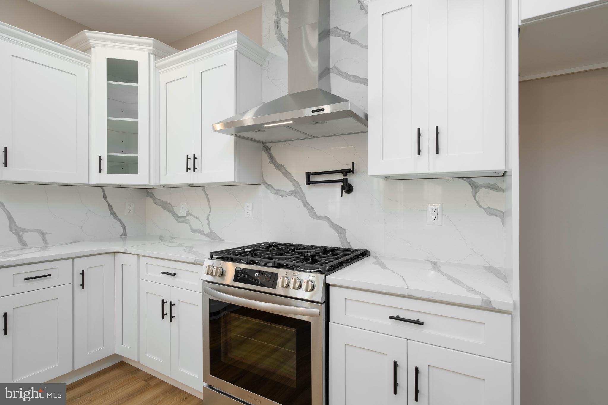 1162 South Spring Road Vineland, NJ 08361 - Photo 15 of 57 a kitchen with stainless steel appliances granite countertop white cabinets and a stove top oven