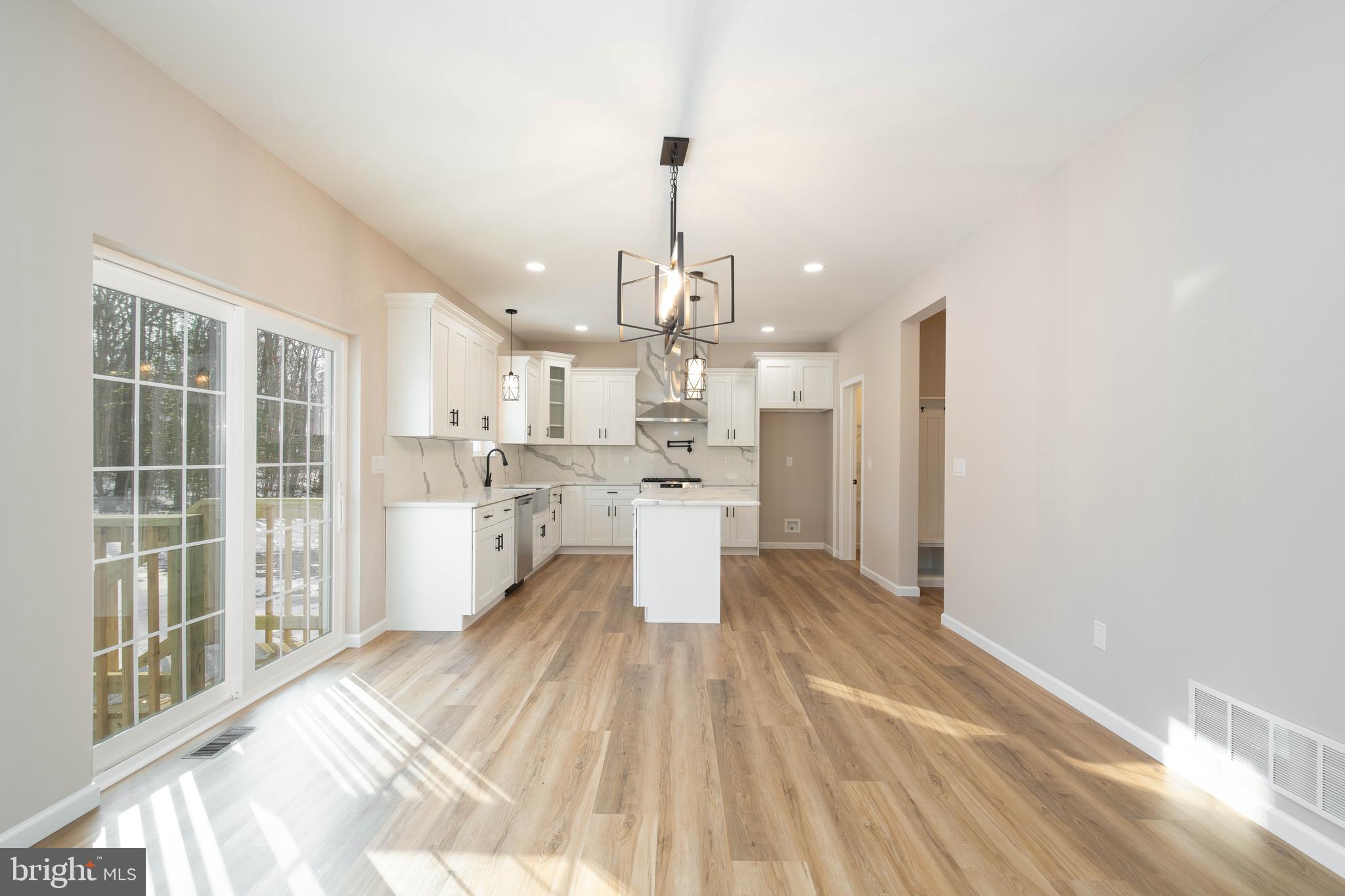 1162 South Spring Road Vineland, NJ 08361 - Photo 23 of 57 a view of a kitchen with kitchen island wooden floor and stainless steel appliances