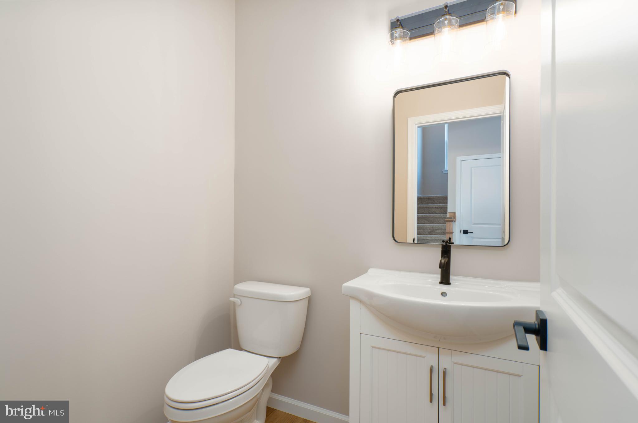 1162 South Spring Road Vineland, NJ 08361 - Photo 26 of 57 a bathroom with a toilet sink and mirror