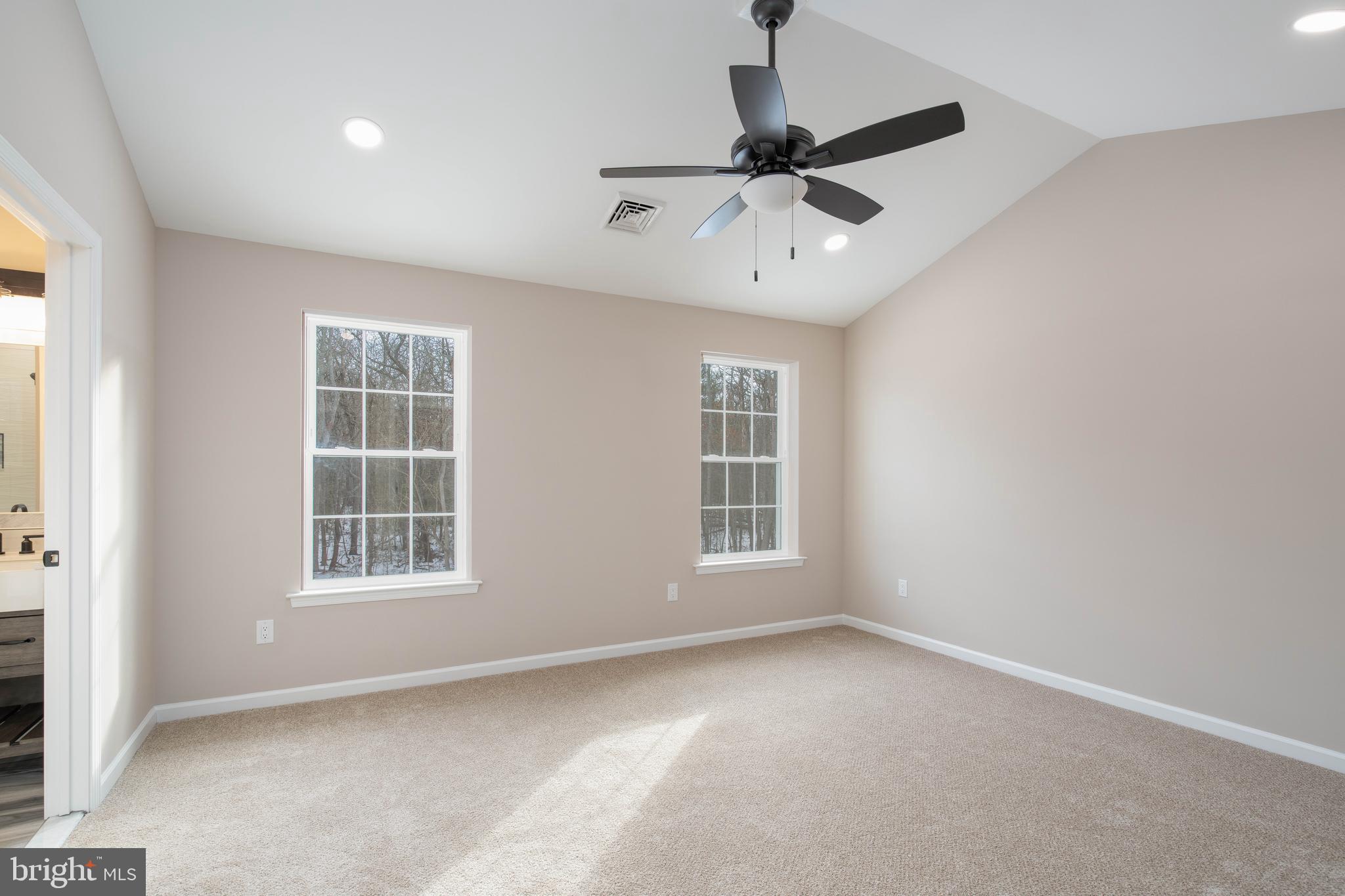 1162 South Spring Road Vineland, NJ 08361 - Photo 40 of 57 an empty room with windows and ceiling fan