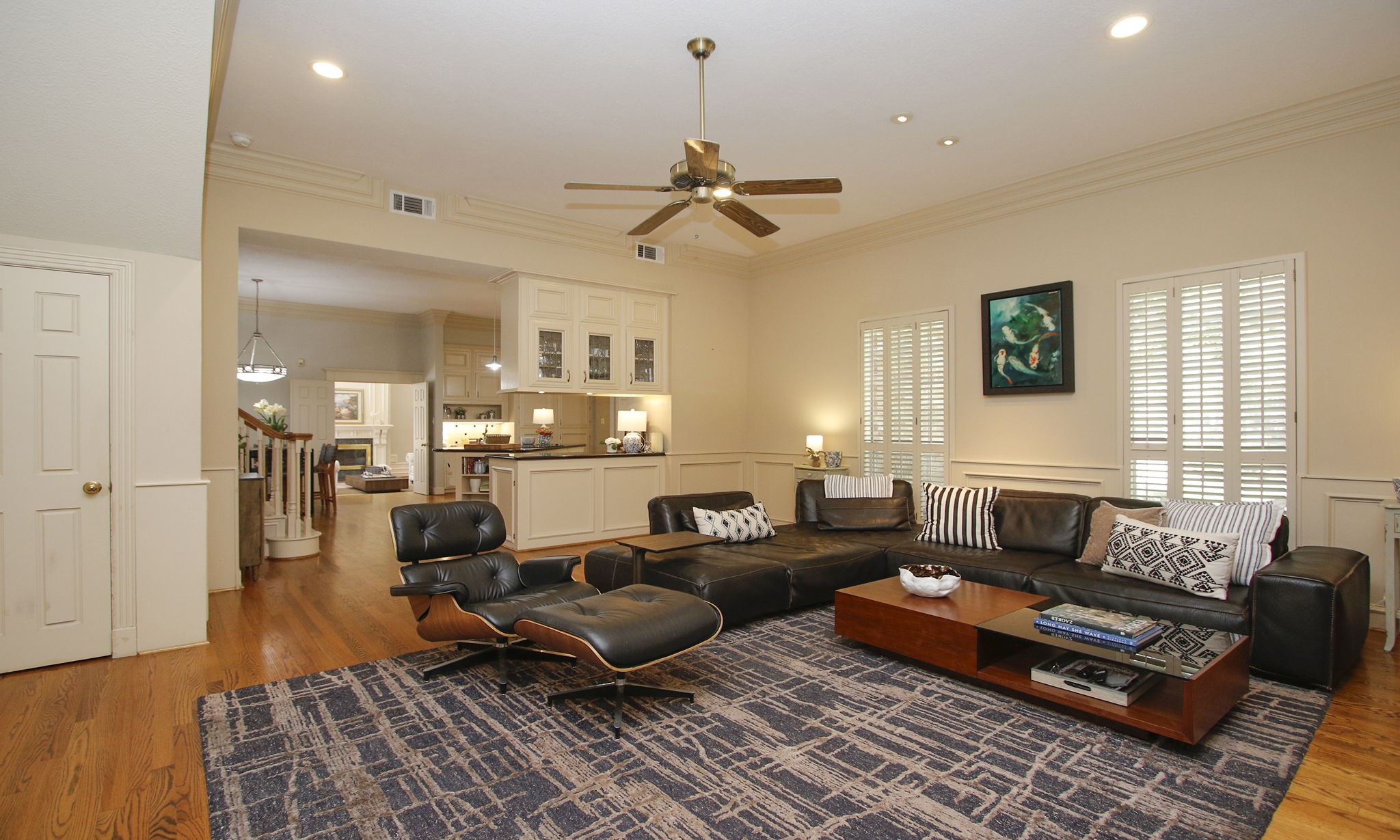 15923 Harwick Drive Spring, TX 77379 - Photo 28 of 50 The family room is just off the kitchen and has hard wood floors and a wall of shuttered windows looking out to the front of the house.