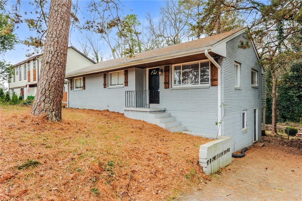 2113 Glendale Drive Decatur, GA 30032 - Photo 1 of 1 a front view of a house with a yard covered in snow