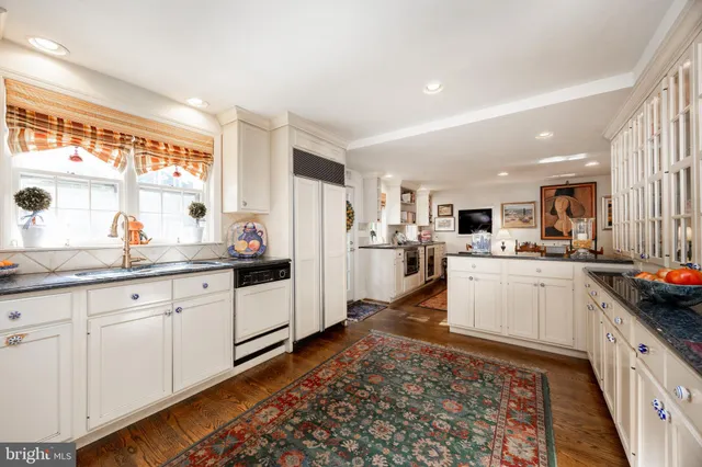 a view of a dining room with furniture and a kitchen