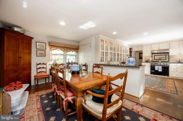 a living room with furniture a large window and a fireplace
