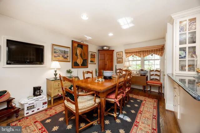 a living room with furniture a fireplace and a large window