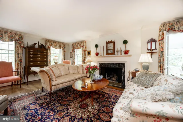 a living room with furniture a rug and a fireplace