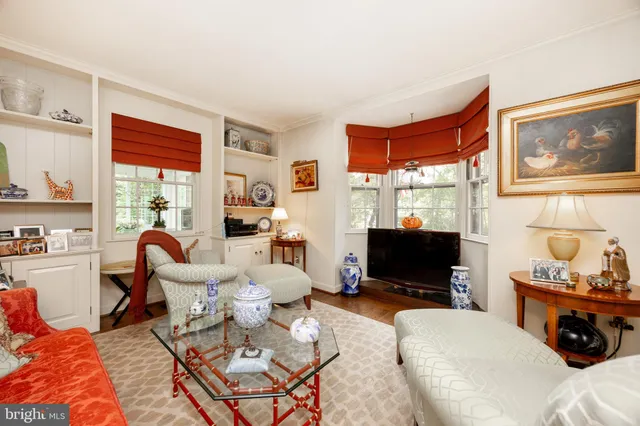 a view of a hallway with wooden floor and a potted plant