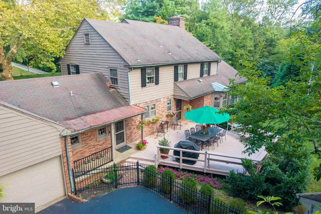 an aerial view of a house with table and chairs