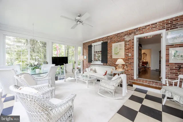 a living room with furniture a rug and a chandelier