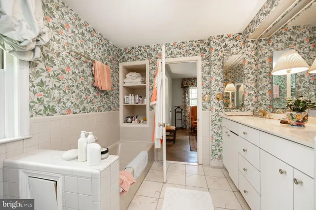 a view of a bedroom with baby crib and wooden floor