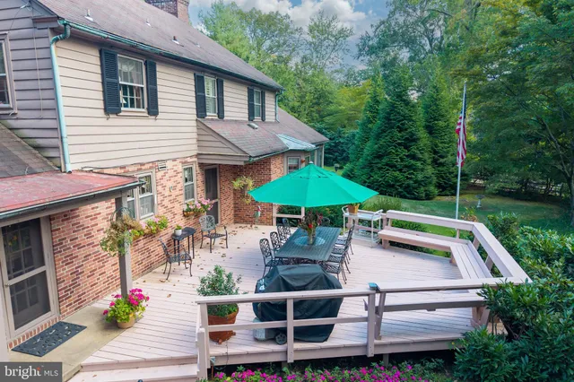 a view of a house with a yard and potted plants