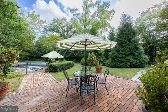 a view of a house with swimming pool and next to a yard