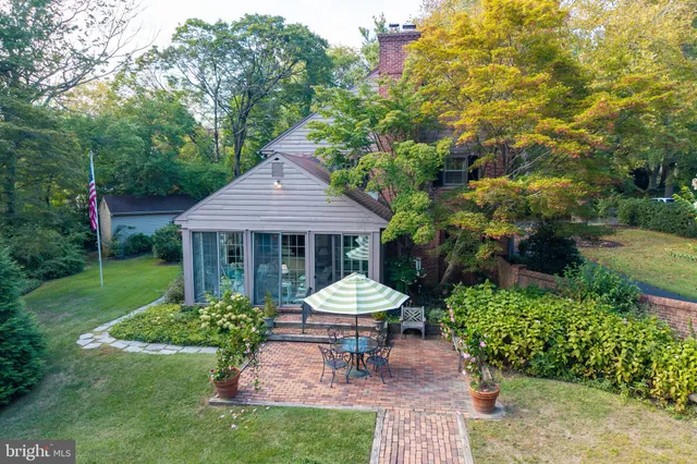 a view of a house with a big yard and potted plants