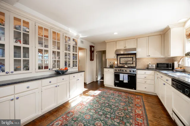 a large white kitchen with lots of counter top space