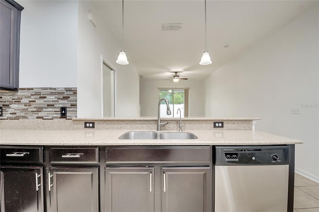 9161 Shepton Street Orlando, FL 32825 - Photo 11 of 62 a kitchen with a sink and cabinets